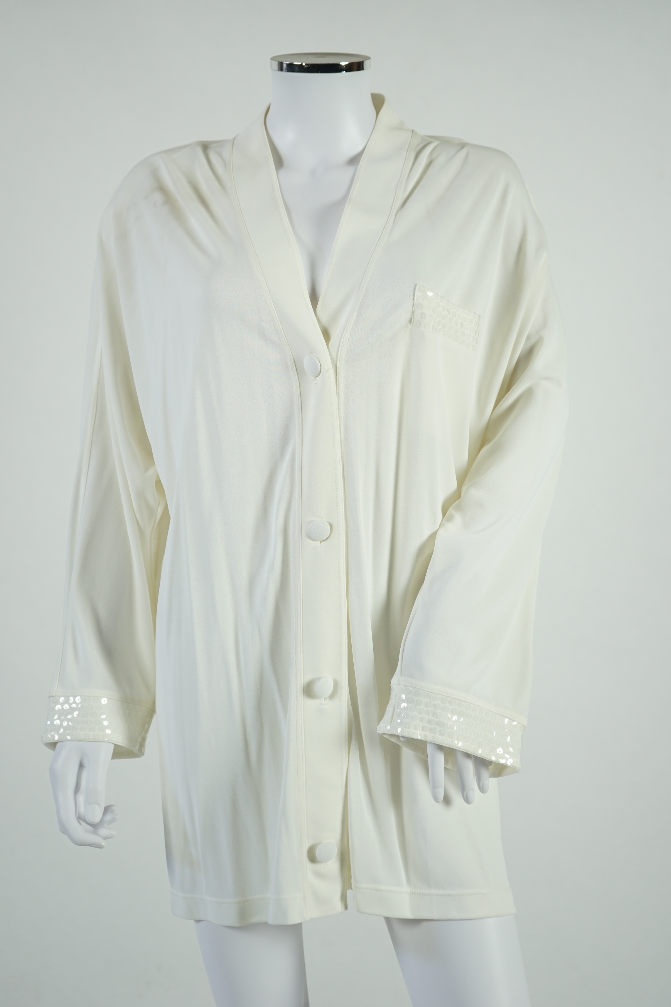 A La Perla white trouser lounge suit, a black jacket lounge jacket, a fawn silk dress and a white embroidered shirt dress. Approx Size L Proceeds to Happy Paws Puppy Rescue